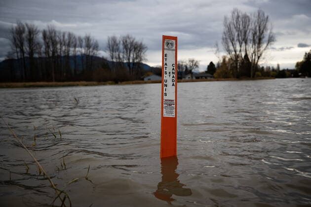 December 1, 2021, ABBOTSFORD, BC, CANADA: A Canada-U.S. border marker is seen surrounded by floodwaters flowing into Abbotsford, B.C., from the U.S., on Wednesday, December 1, 2021. ABBOTSFORD CANADA  - ZUMAc35_ 20211201_zaf_c35_100 Copyright: xDarrylxDyckx