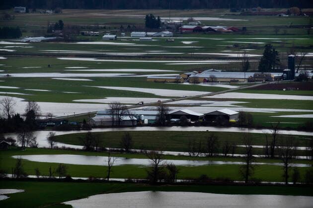 December 1, 2021, ABBOTSFORD, BC, CANADA: Motorists travel on a road surrounded by flooded farmland in Abbotsford, B.C., on Wednesday, December 1, 2021. ABBOTSFORD CANADA  - ZUMAc35_ 20211201_zaf_c35_113 Copyright: xDarrylxDyckx