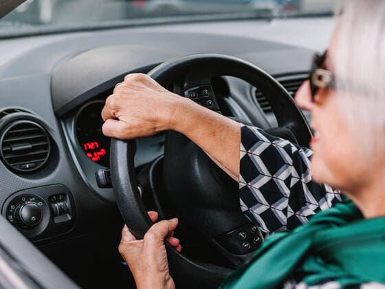 Cheerful senior female in elegant outfit driving modern shiny car in sunny day and looking away HodeiUnzueta_OldWomanDriver_015.jpg Copyright: xHodeixUnzuetax Model Released