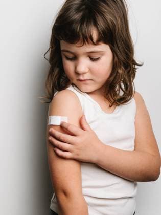 Creative Highlights Symbolbilder Schoolgirl after vaccination standing with band aid on arm, Model released HodeiUnzueta_VaccinatedKids_32.jpg Copyright: xHodeixUnzuetax MR
