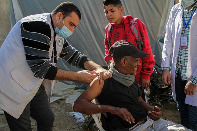 (211202) -- GAZA, Dec. 2, 2021 -- A Palestinian man receives a dose of the COVID-19 vaccine during a vaccination campaign in Gaza City, on Dec. 2, 2021. (Photo by Xinhua) MIDEAST-GAZA CITY-COVID-19-VACCINATION RizekxAbdeljawad 