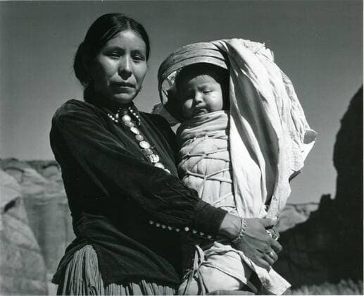 Navajo Woman and infant. Canyon de Chelly National Monument, Arizona. About 1941. Photo by Ansel Adams National Park Service GG Vintage Images 1063_05_Navajo Mother With Child on Cradleboard