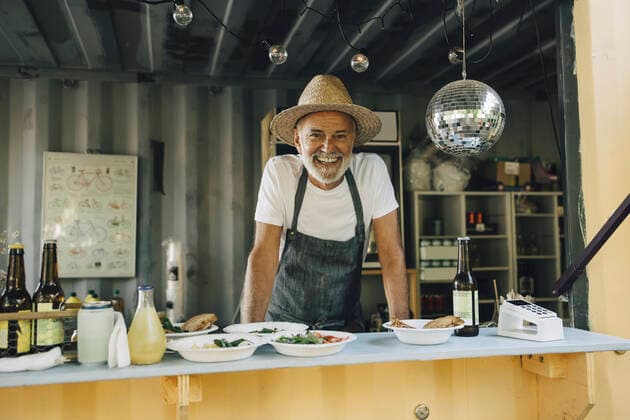 Portrait of smiling male seller in food truck Sweden, Stockholm, model released, property released Copyright: xMaskotx , MA90822
