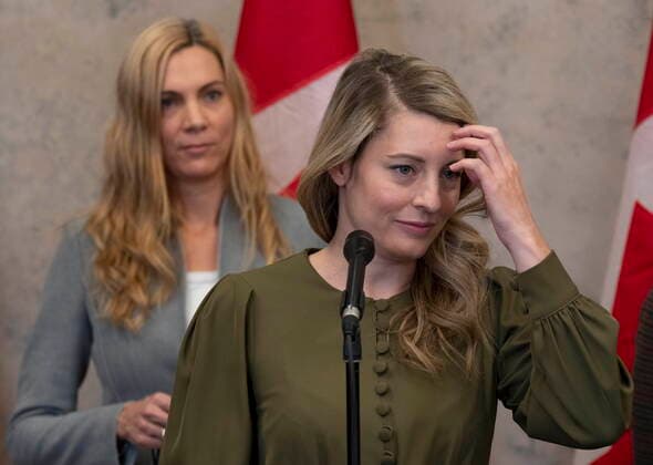 December 8, 2021, Ottawa, ON, Canada: Sport Minister Pascale St-Onge looks on as Foreign Affairs Minister Melanie Joly speaks about a diplomatic boycott of the Winter Games in China following caucus, Wednesday, December 8, 2021 in Ottawa. Ottawa Canada  - ZUMAc35_ 20211208_zaf_c35_050 Copyright: xAdrianxWyldx