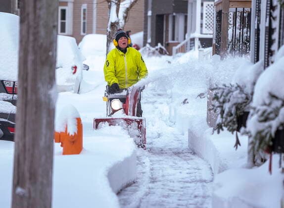 December 9, 2021, Halifax, Nova Scotia, Canada: An area resident clears the sidewalk in Halifax with a snow blower after an overnight snowfall. Schools were closed, transportation impacted and many government and businesses delayed opening as a major winter storm hit the region. Halifax Canada  - ZUMAc35_ 20211209_zaf_c35_005 Copyright: xAndrewxVaughanx