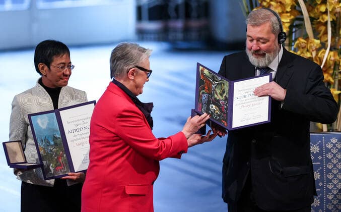 OSLO, NORWAY â€“ DECEMBER 10, 2021: Norwegian Nobel Committee Chairwoman Berit Reiss-Andersen (C) presents the 2021 Nobel Peace Prize to Filipino-American journalist, co-founder and CEO of Rappler Maria Ressa (L) and Russian journalist, Novaya Gazeta editor-in-chief Dmitry Muratov in recognition of their efforts to safeguard freedom of expression, which is a precondition for democracy and lasting peace , at a ceremony at Oslo City Hall. Sergei Bobylev TASS  TS11B5EE
