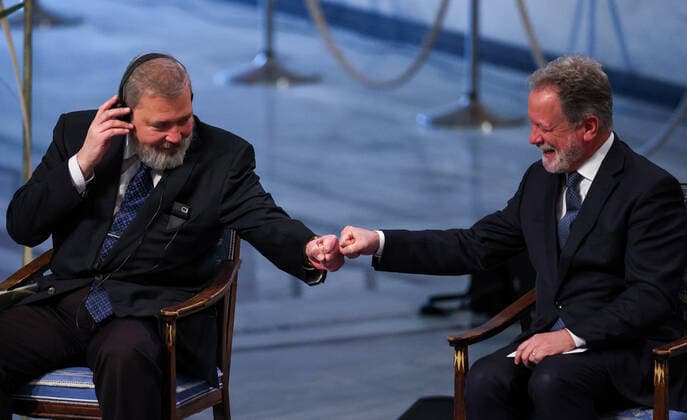OSLO, NORWAY â€“ DECEMBER 10, 2021: 2021 Nobel Peace Prize winner, Russian journalist, Novaya Gazeta editor-in-chief Dmitry Muratov (L) and 2020 Nobel Peace Prize winner, World Food Programme Executive Director David Beasley fist bump during the 2021 Nobel Peace Prize award ceremony at Oslo City Hall. The Norwegian Nobel Committee has decided to award the Nobel Peace Prize for 2021 to Maria Ressa and Dmitry Muratov in recognition of their efforts to safeguard freedom of expression, which is a precondition for democracy and lasting peace . Sergei Bobylev TASS  TS11B5FA