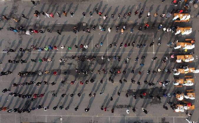 (211210) -- HANGZHOU, Dec. 10, 2021 -- Aerial photo taken on Dec. 10, 2021 shows medical workers taking swab samples at a market in Hangzhou, east China s Zhejiang Province. Eight urban districts of Hangzhou have asked public places, including libraries, museums, theaters and internet cafes, to limit visitors to no more than half of their total capacity. ) CHINA-ZHEJIANG-COVID-19-NUCLEIC ACID TEST (CN) XuxYu 