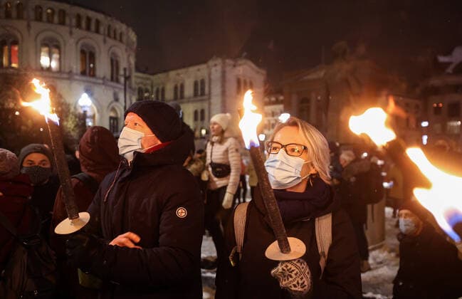 OSLO, NORWAY â€“ DECEMBER 10, 2021: People take part in a torchlight parade in honour of the 2021 Nobel Peace Prize winners from Oslo Central Station to the Grand Hotel where the laureates greet the procession participants from the balcony. The Norwegian Nobel Committee has decided to award the Nobel Peace Prize for 2021 to Filipino-American journalist, co-founder and CEO of Rappler Maria Ressa and Russian journalist, Novaya Gazeta editor-in-chief Dmitry Muratov in recognition of their efforts to safeguard freedom of expression, which is a precondition for democracy and lasting peace . Sergei Bobylev TASS  TS11B672