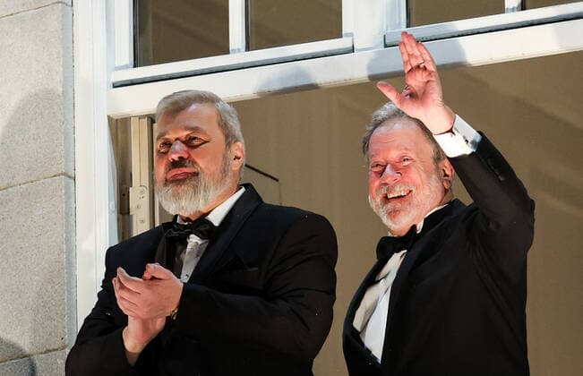OSLO, NORWAY â€“ DECEMBER 10, 2021: Nobel Peace Prize winners, Russian journalist, Novaya Gazeta editor-in-chief Dmitry Muratov (L) and World Food Programme Executive Director David Beasley greet the participants in a torchlight parade in honour of the Nobel Peace Prize winners from a balcony of the Grand Hotel. The Norwegian Nobel Committee has decided to award the Nobel Peace Prize for 2021 to Filipino-American journalist, co-founder and CEO of Rappler Maria Ressa and Russian journalist, Novaya Gazeta editor-in-chief Dmitry Muratov in recognition of their efforts to safeguard freedom of expression, which is a precondition for democracy and lasting peace . The World Food Programme was awarded the Nobel Peace Prize for 2020. Sergei Bobylev T  TS11B690