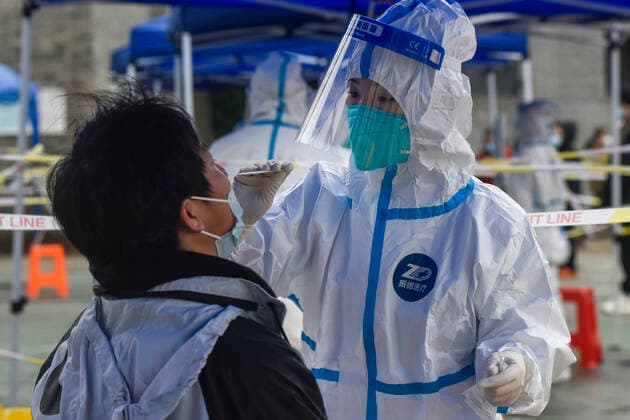 (211212) -- NINGBO, Dec. 12, 2021 -- A medical worker takes a swab sample from a resident for nucleic acid test at a testing site in Zhenhai District of Ningbo City, east China s Zhejiang Province, Dec. 12, 2021. East China s Zhejiang Province registered 138 locally-transmitted confirmed COVID-19 cases and one asymptomatic carrier between Dec. 5 and 3 p.m. Sunday, amid the latest COVID-19 resurgence. Of the total, 44 cases were reported in Ningbo, 77 cases and one asymptomatic carrier were in Shaoxing, and 17 cases were in the provincial capital of Hangzhou, said a provincial government press conference Sunday. (Photo by Xinhua) CHINA-ZHEJIANG-COVID-19-CASES (CN) HuxXuejun 