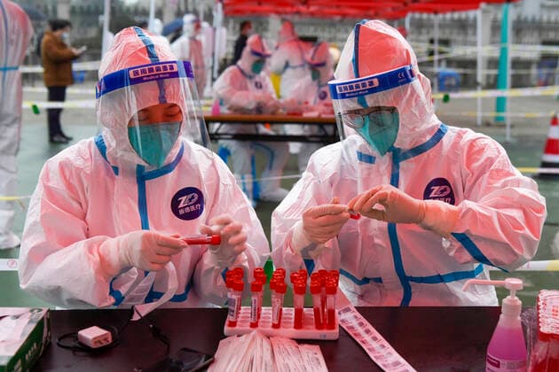 (211212) -- NINGBO, Dec. 12, 2021 -- Medical workers prepare for nucleic acid test at a testing site in Zhenhai District of Ningbo City, east China s Zhejiang Province, Dec. 12, 2021. East China s Zhejiang Province registered 138 locally-transmitted confirmed COVID-19 cases and one asymptomatic carrier between Dec. 5 and 3 p.m. Sunday, amid the latest COVID-19 resurgence. Of the total, 44 cases were reported in Ningbo, 77 cases and one asymptomatic carrier were in Shaoxing, and 17 cases were in the provincial capital of Hangzhou, said a provincial government press conference Sunday. (Photo by Xinhua) CHINA-ZHEJIANG-COVID-19-CASES (CN) HuxXuejun 