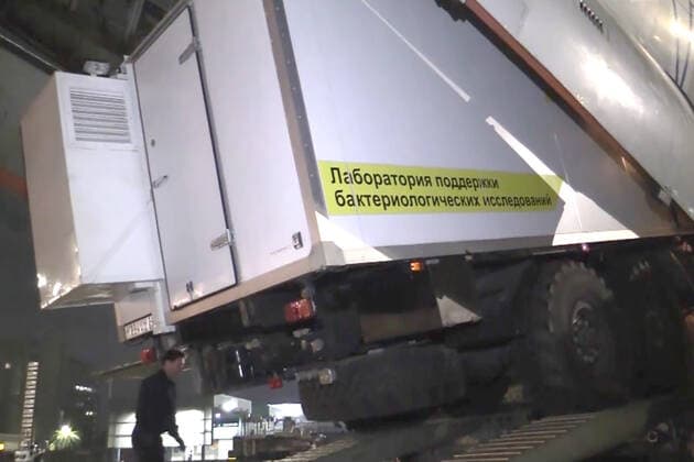 JOHANNESBURG, SOUTH AFRICA â€“ DECEMBER 14, 2021: Unloading a Kamaz lorry equipped with a mobile laboratory of the Rospotrebnadzor Agency from a Russian Emergencies Ministry Ilyushin IL-76 transport aircraft at an airport in Johannesburg. Russia has sent a team of virologists, epidemiologists, Rospotrebnadzor and Russian Health Ministry medical workers, Russian Emergencies Ministry officers and to South Africa amid the COVID-19 pandemic. The mission has been ordered by Russiaâ€™s President Putin in response to a request from South African President Ramaphosa. On 25 November 2021, the South African Ministry of Health reported the emergence of the Omicron variant of SARS-CoV-2 which causes COVID-19. Russian Emergencies Ministry TASS THIS IMAGE  TS11BC1F