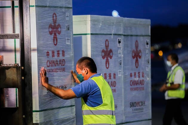(211214) -- PASAY CITY, Dec. 14, 2021 -- A staff member transports cargos containing Sinovac vaccines donated by the Chinese government in Pasay City, the Philippines, Dec. 14, 2021. The Philippines received on Tuesday an additional batch of Sinovac vaccines donated by the Chinese government to help the Southeast Asian country recover quickly from the COVID-19 pandemic. ) PHILIPPINES-PASAY CITY-CHINA-DONATED SINOVAC COVID-19 VACCINES ROUELLExUMALI 