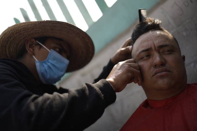 Migrants In Their Stay In Mexico To Continue Their Journey To US MEXICO CITY, MEXICO - DECEMBER 15, 2021: A migrant shaves his colleague s beard, during their stay at House of the Pilgrim San Juan Diego waiting continue their journey heading to the United States border. On December 15, 2021 in Mexico City, Mexico. (Photo by Luis Cortes Eyepix Group) Copyright: xLuisxCortesx xEyepixxGroupx EYEPIXGROUP_MB_15122021_21543
