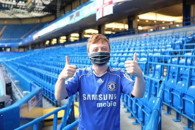 December 18, 2021, London, United Kingdom: Chris White, aged 27, seen thumbs up at the Chelsea Stamford Stadium in his Chelsea jersey, after receiving his booster jab..The Chelsea Stamford Stadium was used as an NHS vaccination centre providing a marathon of jabs ˜Jabathon™. Bookings began from 10am as members of the military and NHS provided the vaccination. London United Kingdom - ZUMAs197 20211218_zaa_s197_124 Copyright: xBelindaxJiaox