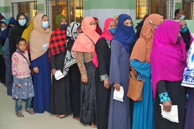 December 20, 2021: 20 December 2021 Sylhet, Bangladesh: Women queue to be able to receive a Pfizer dose against Covid-19 disease at the M A G Osmani medical college & hospital vaccination center in Sylhet. Meanwhile, in Dhaka city of Bangladesh launched the COVID-19 booster shot campaign from Sunday with Pfizer vaccine to scale up its efforts for containing the spread of the lethal virus. - ZUMAr143 20211220_zap_r143_004 Copyright: xMdxRafayatxHaquexKhanx