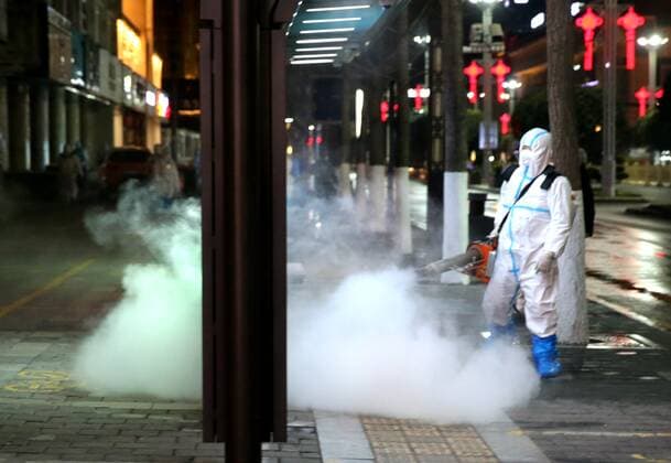XI AN, CHINA - DECEMBER 26: Staff member in protective suit disinfects on street on December 26, 2021 in Xi an, Shaanxi Province of China. Xi an conducted a citywide disinfection since Sunday night to prevent the COVID-19 spread.  Copyright: xVCGx CFP111363040252