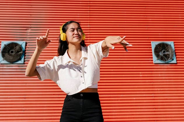 Young woman with headphones dancing on sunny day model released, EGAF02476