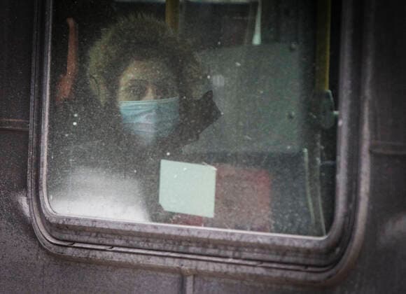(211227) -- VANCOUVER, Dec. 27, 2021 -- A woman wearing a face mask takes a bus in Vancouver, British Columbia, Canada, on Dec. 27, 2021. Canada reported 18,230 new COVID-19 cases Monday noon, elevating the cumulative whole to 2,026,249 cases with 30,172 deaths, according to CTV. (Photo by Xinhua) CANADA-VANCOUVER-COVID-19-CASES-2 MLN LiangxSen