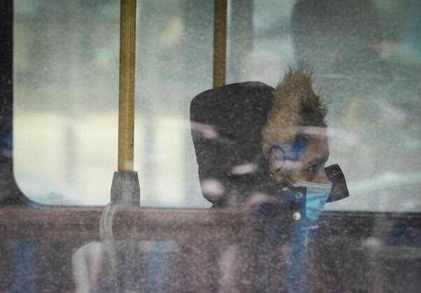 (211227) -- VANCOUVER, Dec. 27, 2021 -- A woman wearing a face mask takes a bus in Vancouver, British Columbia, Canada, on Dec. 27, 2021. Canada reported 18,230 new COVID-19 cases Monday noon, elevating the cumulative whole to 2,026,249 cases with 30,172 deaths, according to CTV. (Photo by Xinhua) CANADA-VANCOUVER-COVID-19-CASES-2 MLN LiangxSen