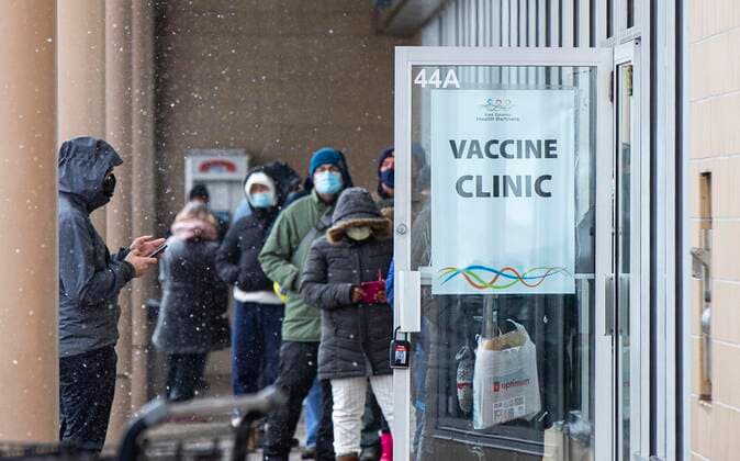 (211227) -- TORONTO, Dec. 27, 2021 -- People wearing face masks line up to enter a COVID-19 vaccine clinic in Toronto, Ontario, Canada, on Dec. 27, 2021. Canada reported 18,230 new COVID-19 cases Monday noon, elevating the cumulative whole to 2,026,249 cases with 30,172 deaths, according to CTV. (Photo by Xinhua) CANADA-ONTARIO-COVID-19-CASES-2 MLN ZouxZheng