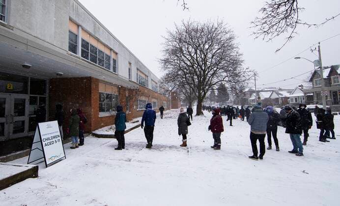 (211227) -- TORONTO, Dec. 27, 2021 -- People wearing face masks line up to enter a COVID-19 vaccine clinic in Toronto, Ontario, Canada, on Dec. 27, 2021. Canada reported 18,230 new COVID-19 cases Monday noon, elevating the cumulative whole to 2,026,249 cases with 30,172 deaths, according to CTV. (Photo by Xinhua) CANADA-ONTARIO-COVID-19-CASES-2 MLN ZouxZheng