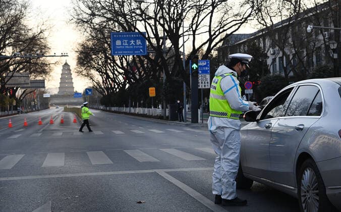 (211229) -- XI AN, Dec. 29, 2021 -- Policemen work on a street in Xi an, capital of northwest China s Shaanxi Province, Dec. 29, 2021. Authorities in Xi an have upgraded epidemic control and prevention measures starting Monday, ordering all residents to stay indoors and refrain from gatherings except when taking nucleic acid tests. ) CHINA-SHAANXI-XI AN-COVID-19-RESURGENCE (CN) TaoxMing 