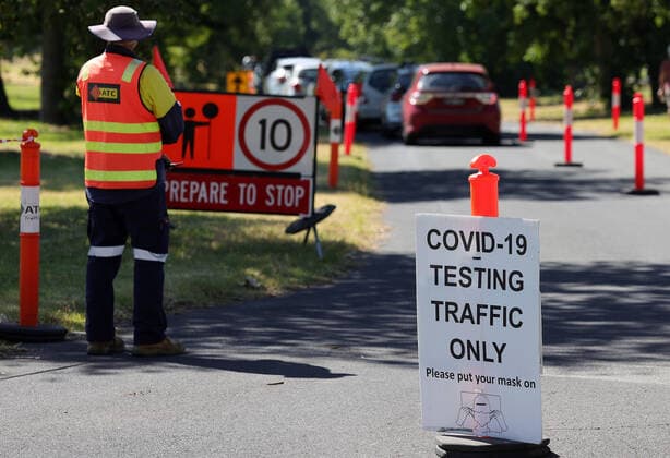 VICTORIA CORONAVIRUS COVID19, A traffic controller watches on as members of the public queue in their cars at a drive-through COVID-19 testing site at Albert Park, in Melbourne, Thursday, December 30, 2021. Victorian travellers getting tested to cross state borders are being asked not to show up at testing sites until after midday in an effort to ease pressure on the system. ( NO ARCHIVING, EDITORIAL USE ONLY, NO USE IN BOOKS WITHOUT CONSENT MELBOURNE VIC AUSTRALIA  Copyright: xCONxCHRONISx 20211230001609758401