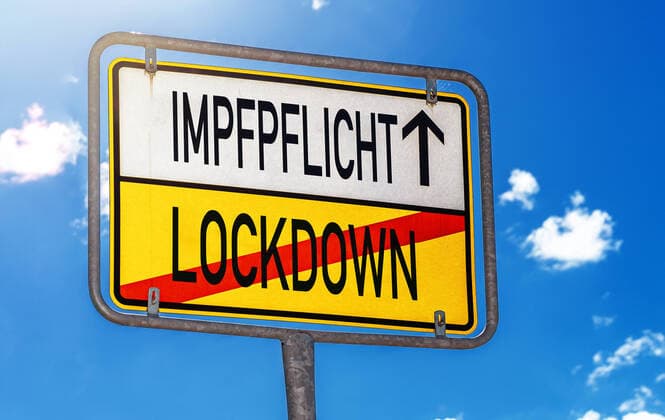 December 30, 2021: Sign reading Mandatory vaccination and lockdown, Covid-19 General vaccination requirement, Coronavirus measures