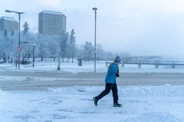 December 30, 2021, Saskatoon, SK, Canada: A pedestrian runs during an extreme cold warning in Saskatoon, Sask. on Thursday, December 30, 2021. Due to a rush of Arctic air, unusually cold weather is observed in Western Canada. A bone-chilling temperature of -38C is recorded in Saskatoon on Thursday morning. Saskatoon Canada  - ZUMAc35_ 20211230_zaf_c35_010 Copyright: xHeywoodxYux