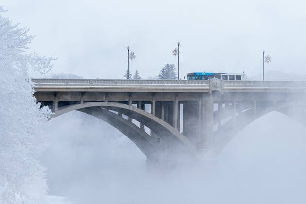 December 30, 2021, Saskatoon, SK, Canada: A bus travels via the Broadway Bridge on South Saskatchewan River during an extreme cold warning in Saskatoon, Sask., on Thursday, December 30, 2021. Due to a rush of Arctic air, unusually cold weather is observed in Western Canada. A bone-chilling temperature of -38C is recorded in Saskatoon on Thursday morning. Saskatoon Canada  - ZUMAc35_ 20211230_zaf_c35_019 Copyright: xHeywoodxYux