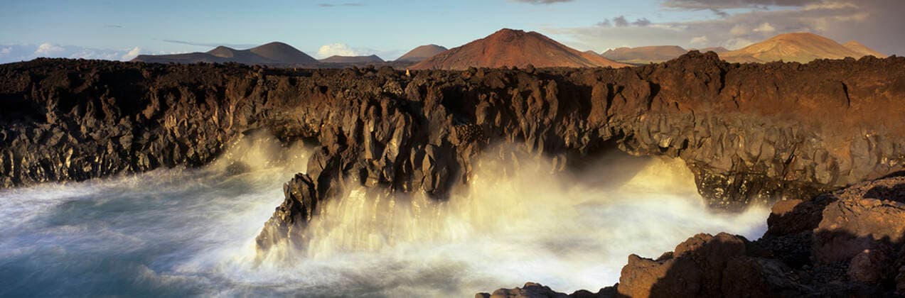 Volcanic coastline with waves crashing into sea caves, Los Hervideros, Timanfaya National Park, Lanzarote, Canary Islands, Spain, Atlantic, Europe Copyright: StuartxBlack 846-3111