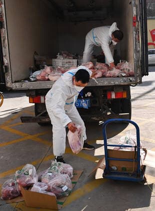 (220101) -- XI AN, Jan. 1, 2022 -- Staff of a food company deliver meat in Xi an, northwest China s Shaanxi Province, Jan. 1, 2022. Xi an, a northwestern Chinese city hit by a recent COVID-19 resurgence, has been making all-out efforts to ensure sufficient food and medicine supplies for its 13 million people who have been under lockdown for over a week. ) CHINA-SHAANXI-XI AN-COVID-19-RESURGENCE (CN) TaoxMing 