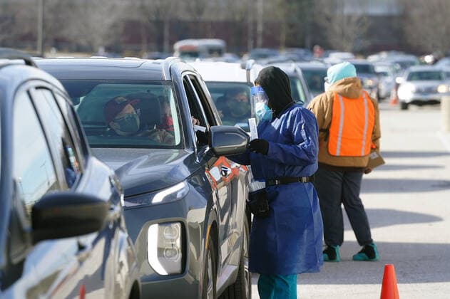 Technicians take Covid testing samples from those that have waited in line at the St. Clair Square Shopping Center & Mall in Fairview Heights, Illinois on Tuesday, January 4, 2022. Technicans say the week long testing sight will experience over 1200 cars each day for Covid testing.  SLP2022010409 BILLxGREENBLATT