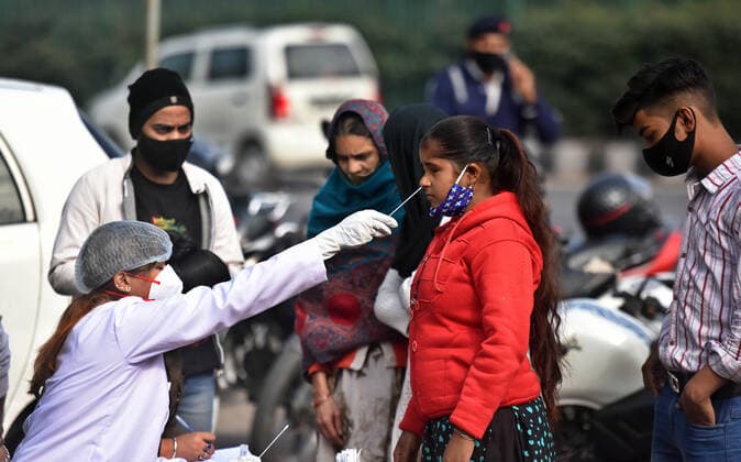 Coronavirus, Eindrücke aus Indien NEW DELHI, INDIA - JANUARY 4: A health worker collects a swab sample for Covid-19 test, during a random testing drive, at Aadhaar Card Office near Akshardham, on January 4, 2022 in New Delhi, India. (Photo by Raj K Raj Hindustan Times ) Daily Life Amid Coronavirus Pandemic In India