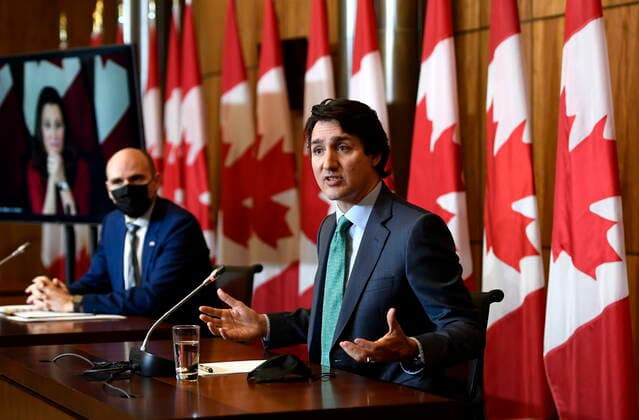 January 5, 2022, Ottawa, ON, CAN: Prime Minister Justin Trudeau speaks as Minister of Health Jean-Yves Duclos and Deputy Prime Minister and Minister of Finance Chrystia Freeland, seen via videoconference, participate in a news conference on the COVID-19 pandemic in Ottawa, on Wednesday, Jan. 5, 2022. Ottawa CAN  - ZUMAc35_ 20220105_zaf_c35_002 Copyright: xJustinxTangx