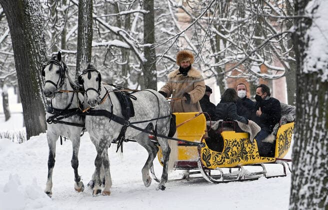MOSCOW REGION, RUSSIA â€“ JANUARY 6, 2022: The French president s diplomatic advisor Emmanuel Bonne and the German Chancellor s foreign and security policy adviser Jens Plotner (L-R back) enjoy a ride on a horse drawn sleigh in the Arkhangelskoye museum estate before Normandy format talks with Deputy Chief of Staff of Russiaâ€™s Presidential Executive Office Dmitry Kozak (not pictured). The talks will discuss Ukraine crisis de-escalation and strengthening strategic stability in Europe. Grigory Sysoyev POOL TASS  TS11E28A