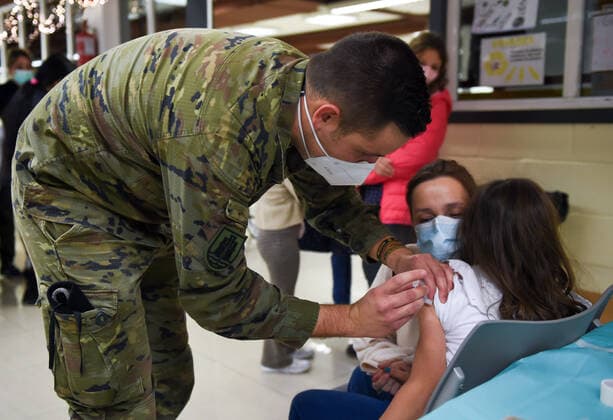 News Bilder des Tages (220108) -- SEVILLE, Jan. 8, 2022 -- A military personnel gives a shot to a child at a vaccination point in Seville University in Seville, Spain, on Jan. 7, 2022. The Spanish Ministry of Health registered 242,440 new cases of the virus from Wednesday to Friday, taking the total number of infections to 7,164,906 in Spain since the start of the pandemic. The Defense Ministry military continue to supply personnel to help with contact tracing and vaccination. (Photo by Xinhua) SPAIN-COVID-19-CASES GustavoxValiente 