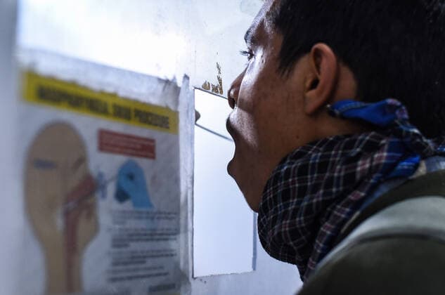 January 8, 2022, Guwahati, India: A health worker collects swab sample for COVID-19 testing at Guwahati Railway Station, in Guwahati, Assam, India on Saturday, Jan. 8, 2022. Daily cases of Covid-19 surged by 21% in 24 hours as India recorded more than hundred thousand fresh infections. Guwahati India - ZUMAt232 20220108_zip_t232_019 Copyright: xDavidxTalukdarx