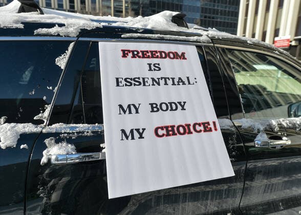 The Media Is The Virus Protest In Edmonton A placard with words Freedom Is Essential: My Body My Choice! attached to the car. Anti-lockdown and anti-vaccination activists meet in the parking lot next to the Alberta Legislature, ahead of the Stand United - The Media Is The Virus! Protest. against Global News, the news and current affairs unit of the Canadian Global Television Network in Edmonton. On Saturday, January 8, 2022, in Edmonton, Alberta, Canada. Edmonton Canada  Copyright: xArturxWidakx originalFilename: widak-themedia220108_npmFI.jpg