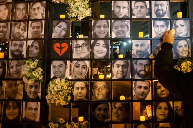 News Bilder des Tages January 8, 2022, TORONTO, ON, Canada: A flower is placed next to the photos of Iman and Parinaz Ghaderpanah on a memorial wall at a vigil in Toronto on Saturday, January 8, 2022. The pair were among the 176 victims of Ukraine International Airlines Flight PS752 that was shot down by Iranian forces two years ago. TORONTO Canada  - ZUMAc35_ 20220108_zaf_c35_132 Copyright: xChrisxYoungx