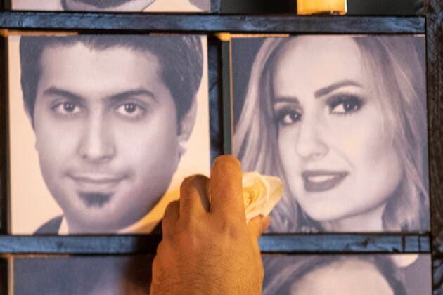 January 8, 2022, TORONTO, ON, Canada: A flower is placed next to the photos of Iman and Parinaz Ghaderpanah on a memorial wall at a vigil in Toronto on Saturday, January 8, 2022. The pair were among the 176 victims of Ukraine International Airlines Flight PS752 that was shot down by Iranian forces two years ago. TORONTO Canada  - ZUMAc35_ 20220108_zaf_c35_135 Copyright: xChrisxYoungx