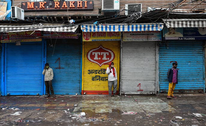 NEW DELHI, INDIA JANUARY 9: People outside shuttered shops in Sadar Bazaar market during the weekend curfew imposed by the Delhi government in wake of rising Covid-19 cases, on January 9 2022 in New Delhi, India. (Photo by Amal KS Hindustan Times ) Delhi Imposes Weekend Curfew To Curb Covid-19 Spread