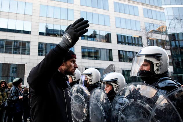January 9, 2022, Brussels, Belgium: A protester stands in front of the police during a demonstration against mandatory Covid-19 vaccination and other government measures to contain the spread of Covid-19 in Brussels, Belgium, January 9, 2022. Brussels Belgium - ZUMAm177 20220109_zip_m177_012 Copyright: xValeriaxMongellix