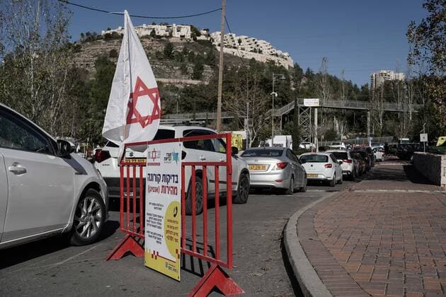 January 10, 2022, Jerusalem, Israel: Drivers queue for hours for COVID-19 tests at the Ein Yael drive thru complex in Jerusalem as Israel faces a surge in Coronavirus infection most likely due to the Omicron variant. Magen David Adom, IsraelÃ¢â‚¬â ¢s leading EMS, conducts PCR tests for the elderly and Antigen tests for all others as a shortage of PCR test kits threatens the near future. Although Antigen tests have proven significantly inaccurate providing both FALSE POSITIVE and FALSE NEGATIVE results, some of the countryÃ¢â‚¬â ¢s economy and education system relies on frequent testing for those not vaccinated. Jerusalem Israel - ZUMAa126 20220110_zap_a126_016 Copyright: xNirxAlonx