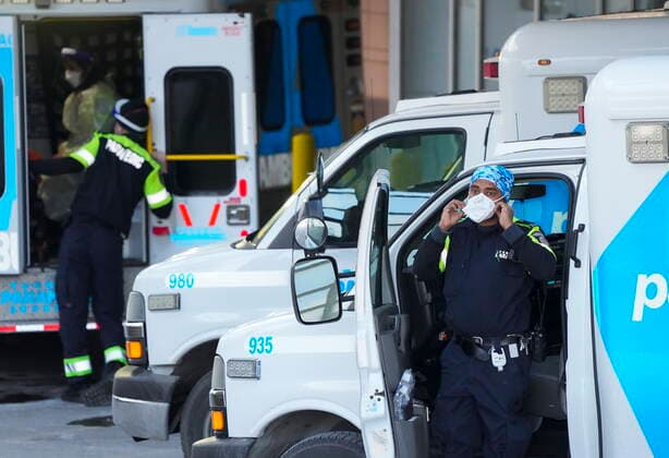 January 10, 2022, TORONTO, ON, CANADA: A paramedic adjusts his protective mask as he transfers a patient out of an ambulance to the emergency department at Michael Garron Hospital during the COVID-19 pandemic in Toronto on Monday, January 10, 2022. Ambulances have been in short supply in some regions through out the province of Ontario. TORONTO CANADA  - ZUMAc35_ 20220110_zaf_c35_018 Copyright: xNathanxDenettex