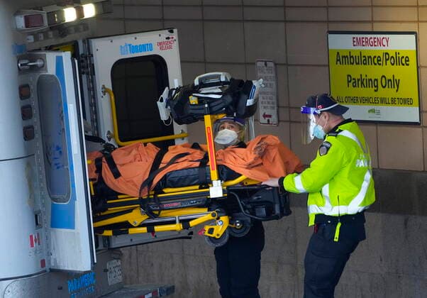 January 10, 2022, TORONTO, ON, CANADA: Paramedics transfer a patient out of their ambulance to the emergency department at Michael Garron Hospital during the COVID-19 pandemic in Toronto on Monday, January 10, 2022. Ambulances have been in short supply in some regions through out the province of Ontario. TORONTO CANADA  - ZUMAc35_ 20220110_zaf_c35_021 Copyright: xNathanxDenettex