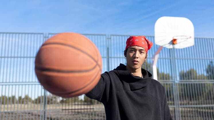 IMAGO Creative: 2022 Sport Favoriten Serious Asian male in sportswear with basketball in hand looking at camera while standing on sports ground during training, Model released SheyNunez_AronBenitoPangilinanVallecas_19.jpg Copyright: xSheyxNunezx MR