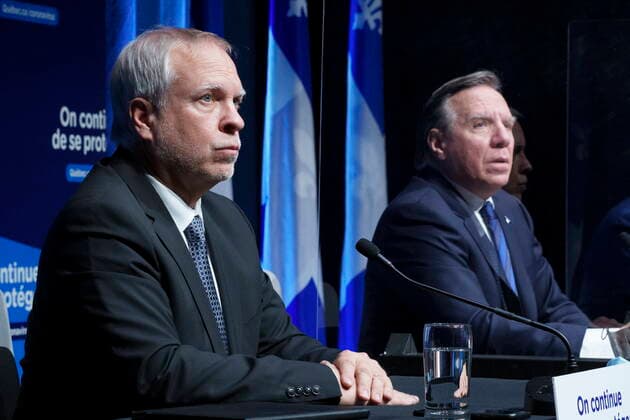 January 11, 2022, Montreal, PQ, Canada: Dr. Luc Boileau, interim Quebec Director of Public Health and Quebec Premier Francois Legault listen to a question during a news conference in Montreal, Tuesday, Jan. 11, 2022. Montreal Canada  - ZUMAc35_ 20220111_zaf_c35_029 Copyright: xPaulxChiassonx